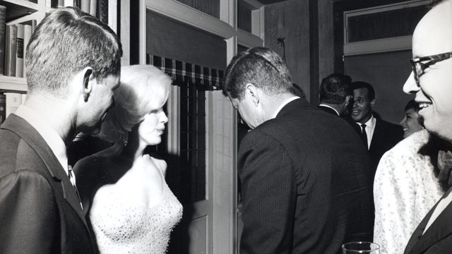 Marilyn Monroe speaks to US President John F. Kennedy. 